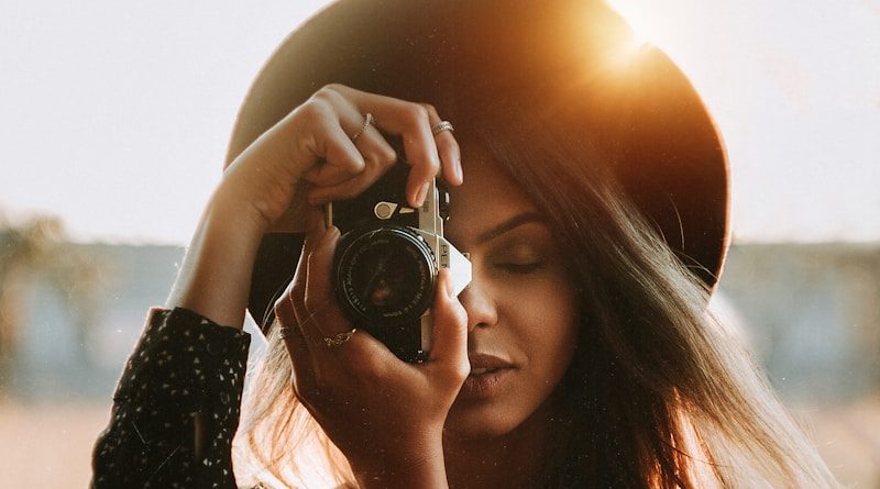 woman in black long sleeve shirt holding black dslr camera